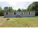 Front view of a charming home featuring neutral siding, green lawn, and traditional front door at 3035 Agean Ln, York, SC 29745