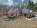 Brick house with gray roof and detached shed; spacious yard at 3119 Drake Ln, Monroe, NC 28110