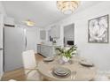 Dining area features an elegant chandelier and a table set for a delightful meal at 4321 Bobterry Ct, Charlotte, NC 28216