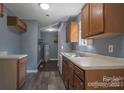 Kitchen with wood cabinets, neutral countertops, and vinyl flooring at 4335 Saluda Rd, Rock Hill, SC 29730