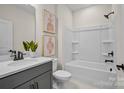 Clean bathroom with grey vanity, bathtub, and neutral wall tiles at 4791 Formation Ct # 102, Lancaster, SC 29720