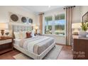 Cozy bedroom with large windows, hardwood floors, and neutral decor at 4791 Formation Ct # 102, Lancaster, SC 29720