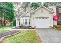 Inviting home featuring a one car garage, tidy landscape, and well-kept lawn at 4918 Sunset Ridge Ct, Charlotte, NC 28269