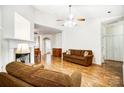 Cozy living room features hardwood floors, ceiling fan, and neutral colors at 4918 Sunset Ridge Ct, Charlotte, NC 28269