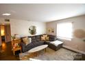 Living room with L-shaped sofa and decorative accents at 4923 Park Rd # D, Charlotte, NC 28209