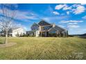 Two-story house with a green lawn and partial view of the neighborhood at 501 Alucio Ct, Matthews, NC 28104