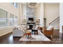 Bright living room featuring built-in shelving, a cozy fireplace, and large windows offering ample natural light at 501 Alucio Ct, Matthews, NC 28104