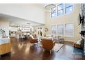 Open-concept living room with tall ceilings, a stone fireplace, and a seamless flow to the kitchen at 501 Alucio Ct, Matthews, NC 28104