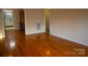 Hardwood floor dining room with built-in hutch and kitchen view at 518 Oak St, Troy, NC 27371