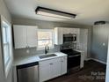 Well-lit kitchen featuring stainless steel appliances, white cabinets, and modern countertops at 552 6Th St, Chester, SC 29706