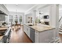 Modern kitchen with island, white cabinets, and stainless steel appliances at 6819 Conservatory Ln, Charlotte, NC 28210