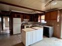 An empty kitchen with wood cabinets, an island, and tile countertops at 6862 Royal Heights Cir, Hickory, NC 28602