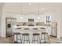 Modern kitchen with white cabinets, large island, and stainless steel appliances at 7504 Surry Ln, Indian Trail, NC 28079