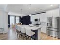 Modern kitchen with white cabinets, quartz countertops, and island at 8119 Merryvale Ln, Charlotte, NC 28214