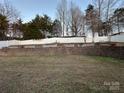 Landscaped backyard with retaining wall and fence at 959 Avery Ct, Concord, NC 28025