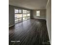 Bright living room showcasing large windows and wood-look flooring at 1064 S Stonewall Ave, Rock Hill, SC 29732