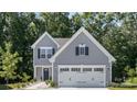 Gray house with white garage doors and landscaping at 1163 Ryan Meadow Dr, Monroe, NC 28110