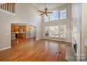 Spacious living room with hardwood floors, high ceilings, and a fireplace at 11805 Prestmoor Ct, Charlotte, NC 28262