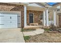 Brick front porch with white columns and a dark gray front door at 141 Silverspring Pl, Mooresville, NC 28117