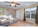 Living room with hardwood floors, a fireplace, and a large window at 14311 Riding Hill Ave, Charlotte, NC 28213