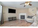 Living room with fireplace, hardwood floors, and a large TV at 14311 Riding Hill Ave, Charlotte, NC 28213