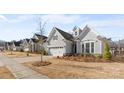 View of a well-kept home showcasing a well-manicured lawn and beautiful landscaping at 14531 Crosswater Ln, Charlotte, NC 28278