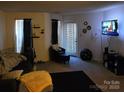 Living room with grey couch, dark rug, and a large TV at 15 Hamiltons Bay Ct # A939, Lake Wylie, SC 29710