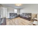 Living room with gray reclining sofas and wood-look floors at 1529 Cannan Mountain Dr, Newton, NC 28658