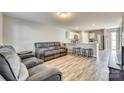 Open living space with gray reclining sofas and wood-look floors at 1529 Cannan Mountain Dr, Newton, NC 28658