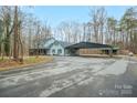 House with carport and detached shed, spacious driveway, and wooded setting at 161 Moore Haven Dr, Salisbury, NC 28147