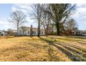 Side view of a ranch house with a large yard at 1979 Charlotte Hwy, Mooresville, NC 28115