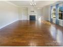 Bright living room featuring hardwood floors and fireplace at 2219 Lochview St, Pineville, NC 28134