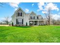 Charming two-story home featuring a well-maintained lawn and inviting craftsman architecture at 3428 Greene Rd, Monroe, NC 28110