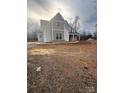 Two-story house with gray and beige siding, unfinished yard and driveway at 3428 Greene Rd, Monroe, NC 28110