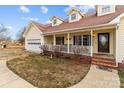 Detailed view of the home's exterior, highlighting the porch and entryway at 36190 Millingport Rd, New London, NC 28127