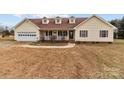 House exterior showcasing a ranch-style home with a front porch and attached garage at 36190 Millingport Rd, New London, NC 28127