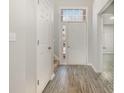 Bright entryway with wood-look floors and white door at 3821 Bullard St, Charlotte, NC 28208