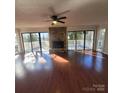 Spacious living room with hardwood floors and stone fireplace at 4066 Triton Dr, Tega Cay, SC 29708