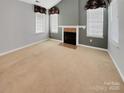 Spacious living room with a fireplace and neutral color scheme at 5573 Prosperity View Dr, Charlotte, NC 28269