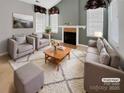 Virtually staged living room features fireplace and neutral decor at 5573 Prosperity View Dr, Charlotte, NC 28269