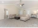 Open-concept living room featuring plush carpeting, a ceiling fan, and neutral tones at 5904 Bryant Ln, Waxhaw, NC 28173