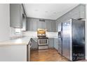 Gray kitchen with stainless steel appliances at 604 E Louisiana Ave, Bessemer City, NC 28016