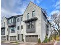 Townhome boasts an elegant painted brick facade, a two-car garage, and professionally landscaped yard at 6133 Berryhill Towns Dr, Charlotte, NC 28270