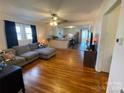 Comfortable living space blending into the kitchen, featuring hardwood floors and a cozy gray sectional sofa at 7860 Georgia Ave, Kannapolis, NC 28081