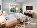 Bright bedroom with large window and modern dresser at 8835 Merrie Rose Ave, Charlotte, NC 28213