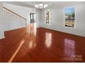 Bright dining room featuring hardwood floors and wainscoting at 8835 Merrie Rose Ave, Charlotte, NC 28213