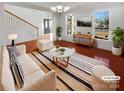 Virtually staged living room with hardwood floors and a neutral color palette at 8835 Merrie Rose Ave, Charlotte, NC 28213