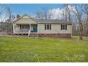 Charming single Gathering home featuring a inviting front porch and a well-maintained lawn at 1025 Twin Lakes Rd, Rock Hill, SC 29732