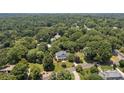 Estate aerial view revealing the setting amid a lush, dense forest surrounding the property at 110 Lynbrook Dr, Davidson, NC 28036