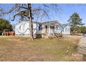 Side view of a white doublewide home with blue shutters and a covered porch at 111 Green Dr, Richburg, SC 29729